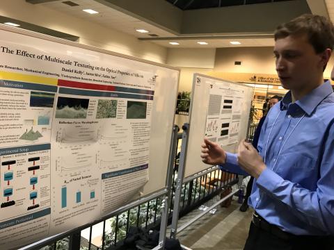 Photo of Daniel discussing his poster