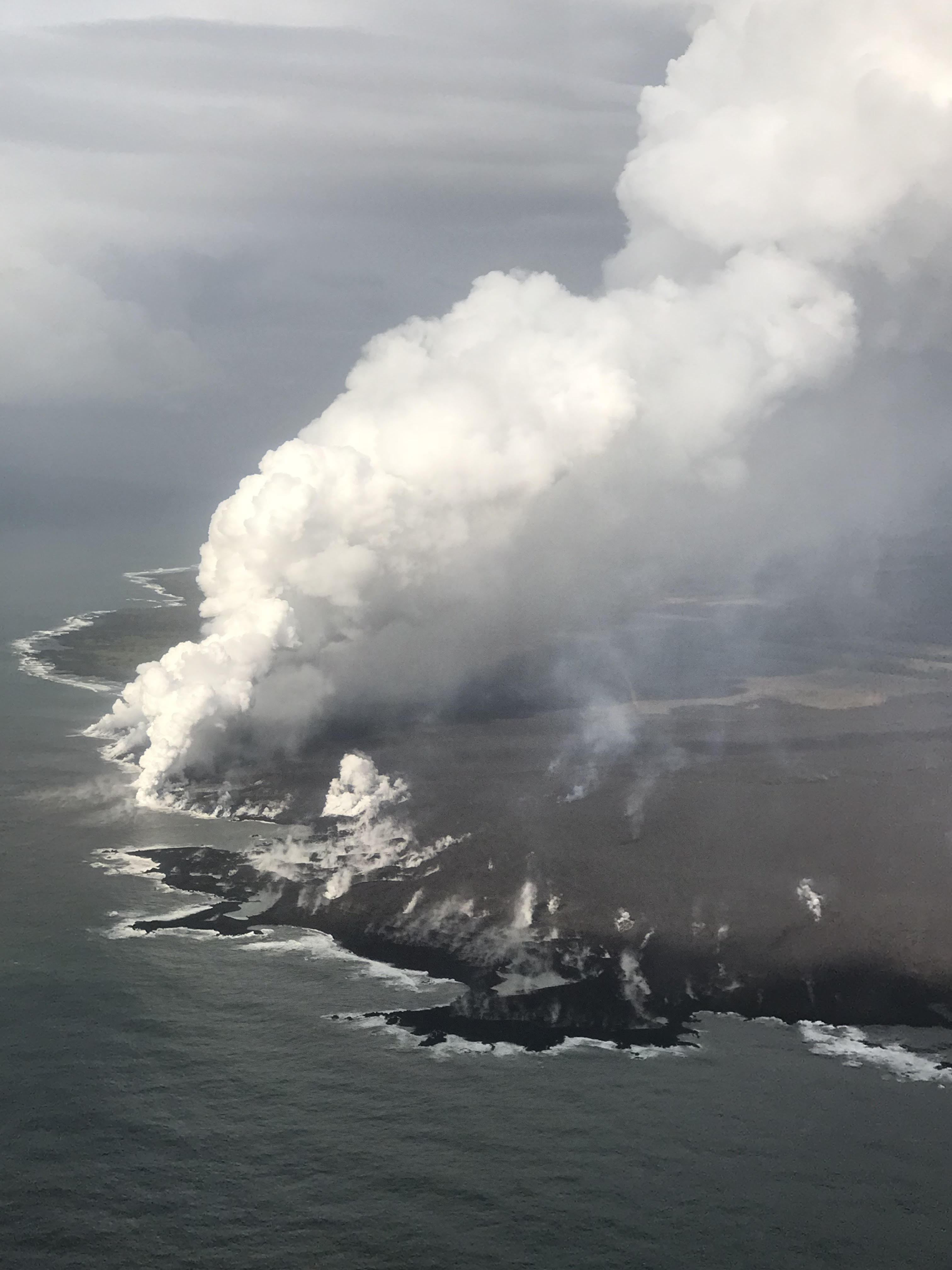 Aerial photo of lava running into ocean