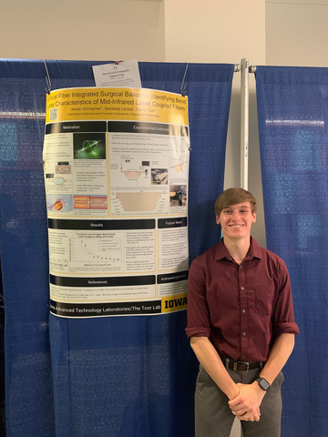 Xavier Uhrmacher poses with his research poster