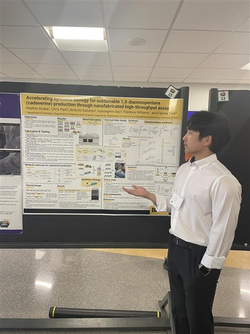 A student standing by a research poster