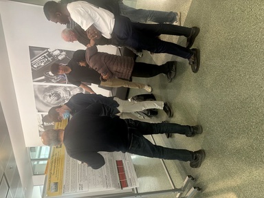 People discussing a research poster