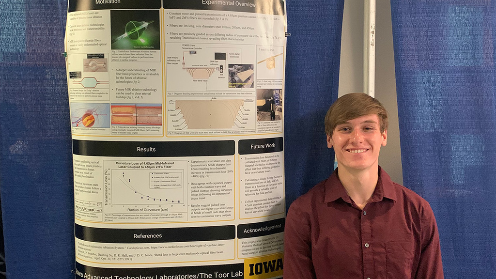 Xavier Uhrmacher poses with his research poster